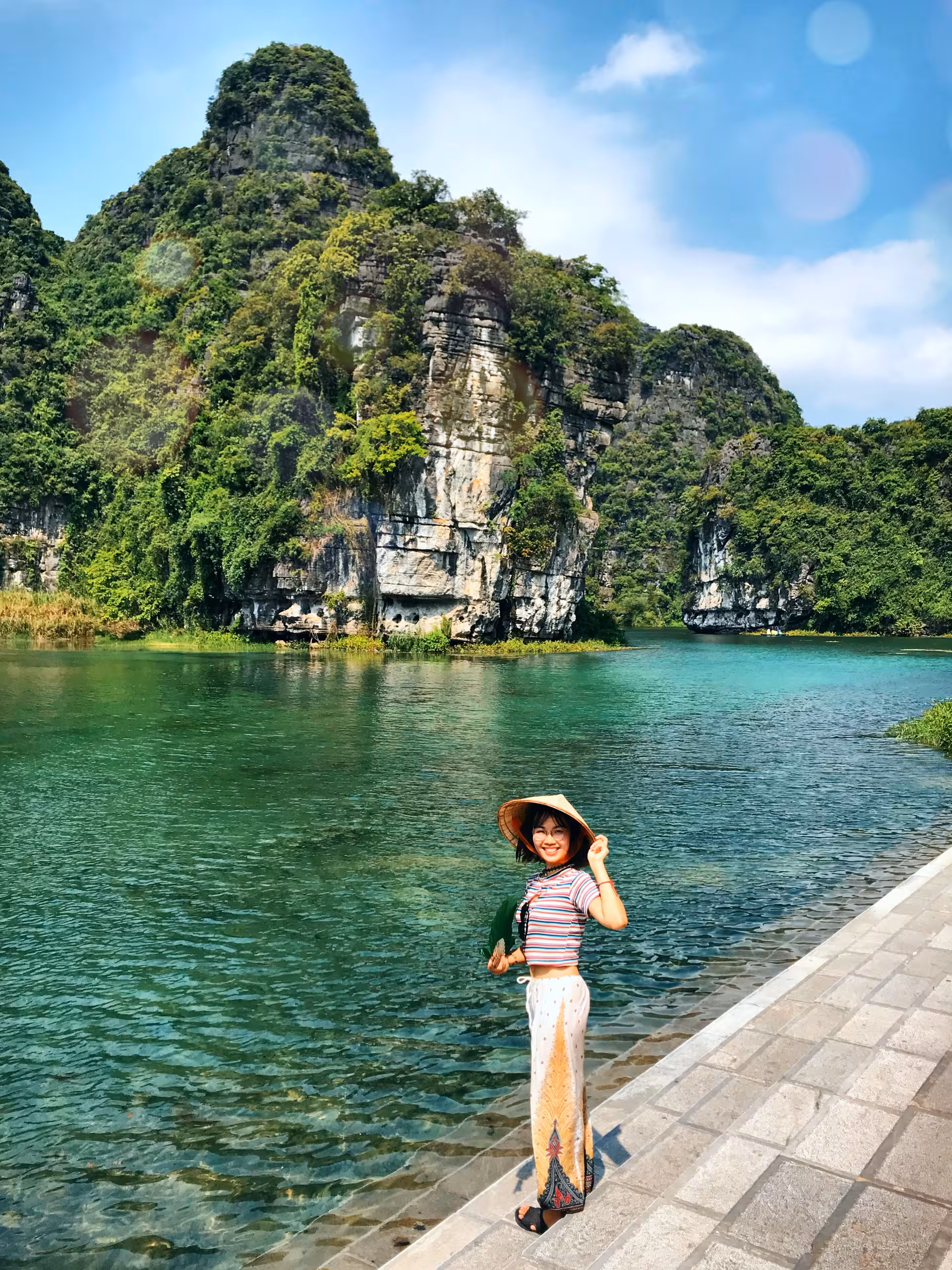1st PICK D7 8 NINH BINH Our Adventure Leader Smiles by the Water with Cliffs.jpeg